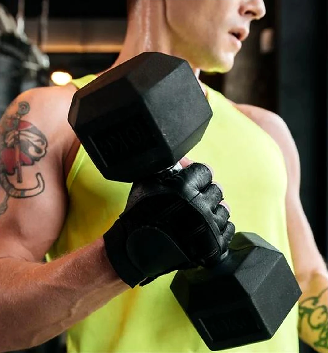 Fitness athlete holding dumbbells in a gym
